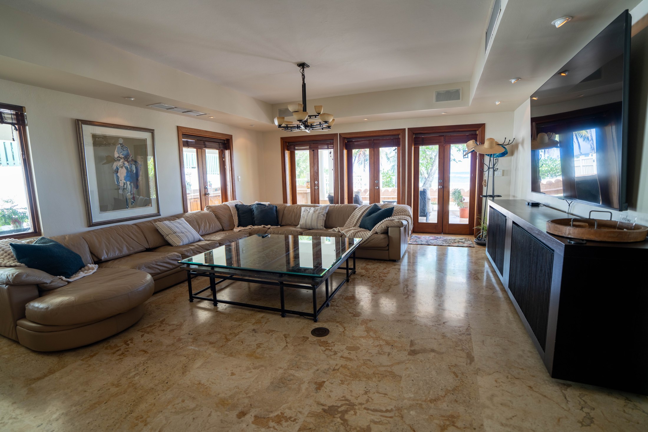 Living room with large sectional opening to the ocean-view doors